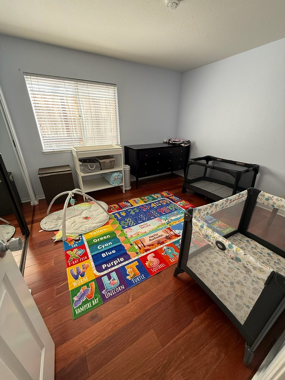 Our infant room: changing station, cribs, and a soft play mat