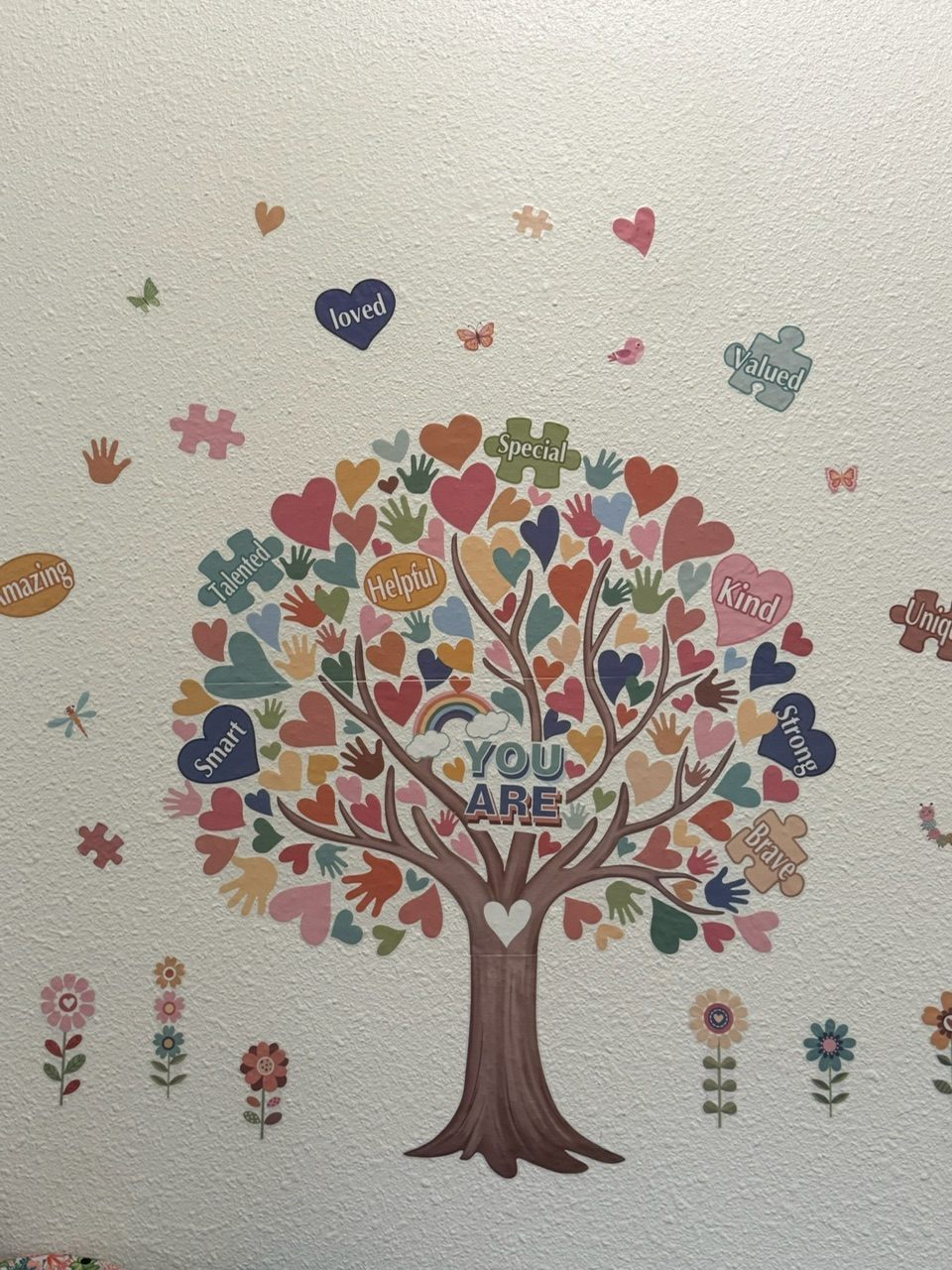 Wall art of a tree filled with hearts and the words: you are kind, brave, smart, loved, valued